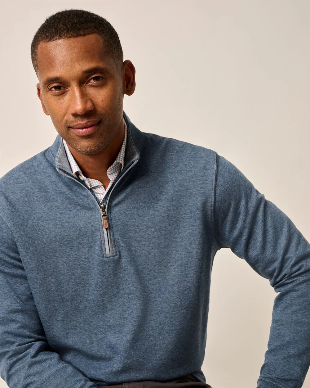 Man wearing a blue sweater with a white background