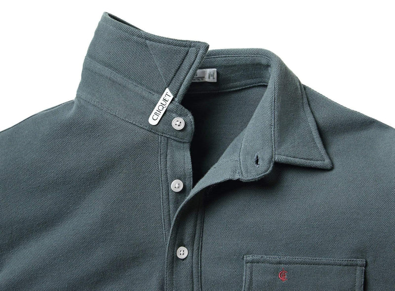 Close-up of a gray polo shirt with collar and buttons, featuring a brand label.